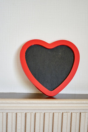chalkboard  with red heart shape frame on top wood panelの写真素材