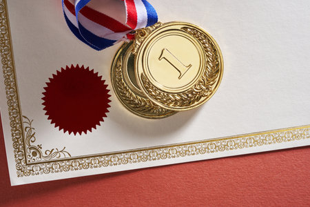 blank certificate and gold medal with ribbonの写真素材