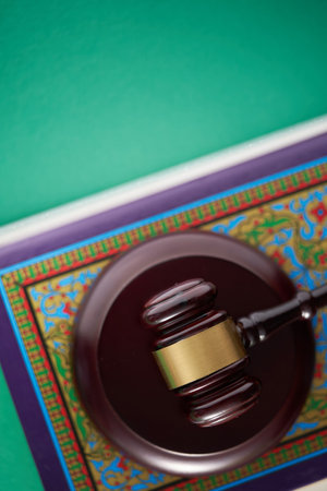 Sharia or Islamic law concept with gavel and koran on green backgroundの写真素材