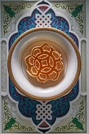 ramadan honeycomb cookieor kuih loyang against against arabic design food trayの写真素材