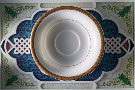 golden saucer on arabic design wooden tray