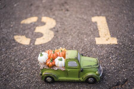 Green harvest truck full of Colorful fall pumpkins with blurred background. Thanksgiving wallpaperの写真素材