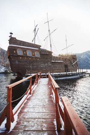 SAYANOGORSK, RUSSIA, DECEMBER 2014 - Entertainment boat for tourist trips, replica of the famous Black Pearl from the movie Pirates of the Caribbean docked in the bay of Yenisey River, South Siberia.のeditorial素材