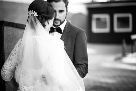 The bride and groom black and white portrait. The man has a serious look, wedding retro classic.の写真素材