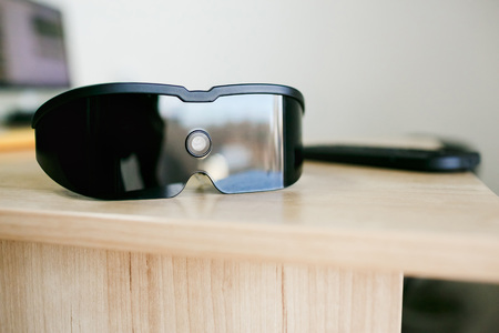 Virtual reality headset laying on office tableの写真素材