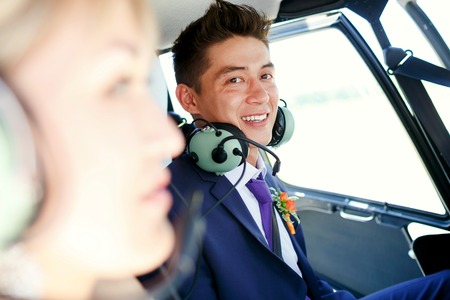 The groom in a helicopter, wearing headphonesの写真素材