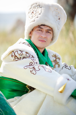 Portrait of a man on the grass in the traditional clothes looking at the camera,の写真素材