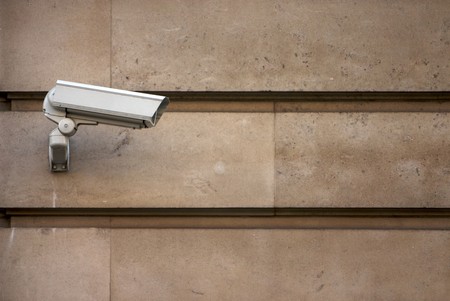 CCTV camera on stone-clad wallの写真素材