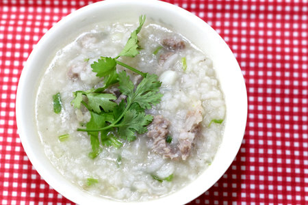 Rice Soup with pork and machines in a white Cup.の写真素材