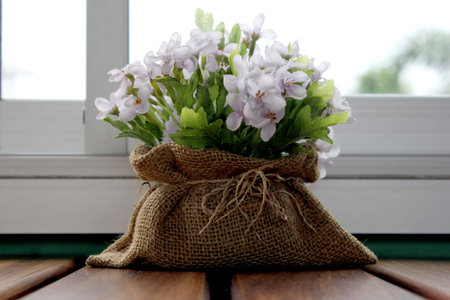 colorful flowers sack decoration on wooden table
