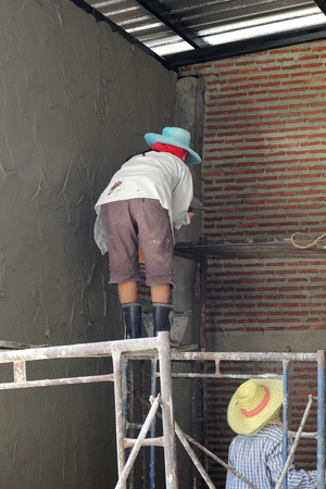 Image of a construction worker mixing cement.の写真素材