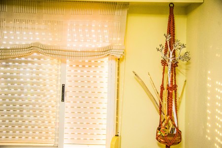 Closed blind in which light enters the slits in the interior of a house with exterior windowの写真素材