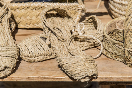 Craft shoes made of esparto for sale stacked on top of each otherの写真素材
