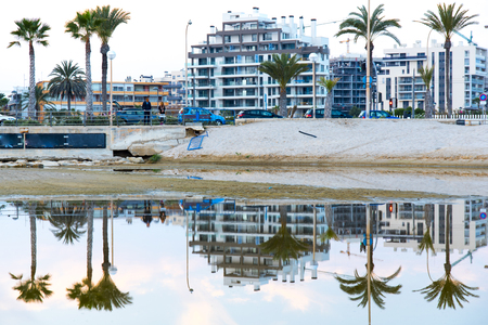 Reflections on the water at sunset. On a beach at the end of the day on summer beach on the beach of San Juan, Alicante Spainの写真素材