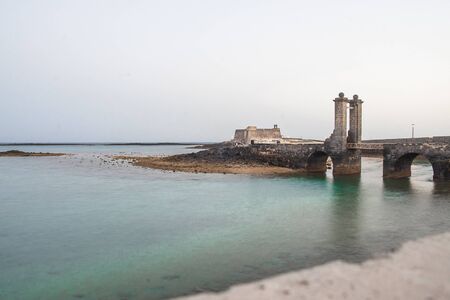 Stone bridge over the port and the sea in the bay of Arrecife in Lanzarote Canary Islandsの写真素材