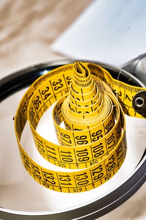 Yellow dressmaker's tape measure for clothing and its derivativesの写真素材
