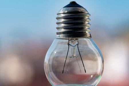 Transparent filament spherical light bulb which is currently no longer in use on a nice bright and...