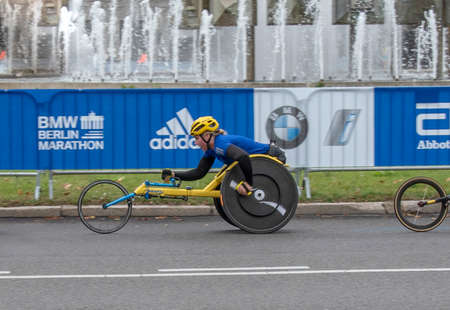 Berlin, Germany, Europe, 09/29/2019  The Berlin marathon. Outstanding wheelchair runner passing exactly at kilometer 12 of the startのeditorial素材