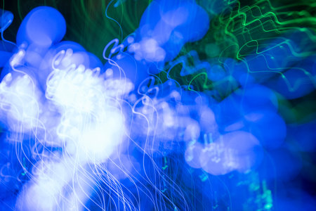 Colorful psychedelic lights and shadows in a dazzling stream of diverse lightの写真素材