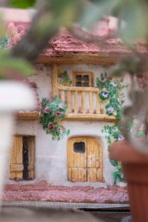 Miniature house in the garden. Miniature house made of clay.の写真素材