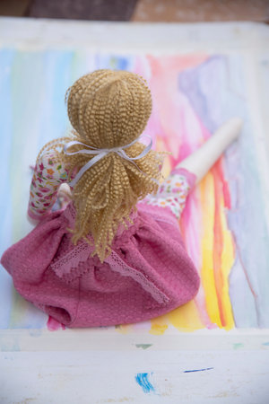 toddler doll on the colorful background, vintage style, selective focusの写真素材
