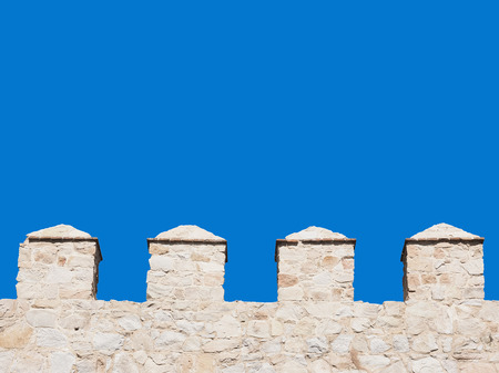 pinnacles of a wall isolated on blue sky to use as backgroundの写真素材