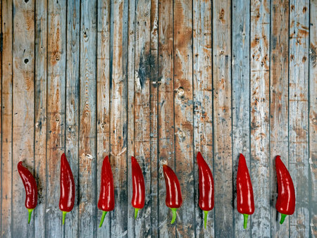 Design of dark wood background with chili peppers