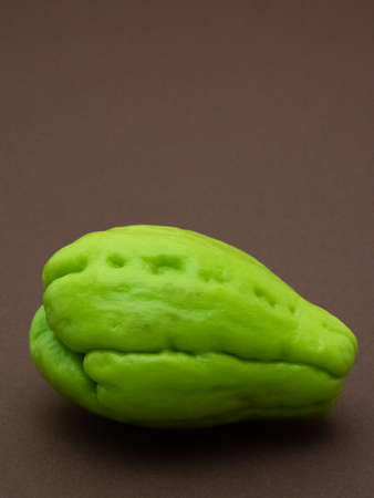 Chayote fruit isolated on brown backgroundの写真素材