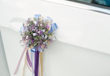 Beautiful wedding car decoration. A small bouquet of lavender with ribbons.の写真素材