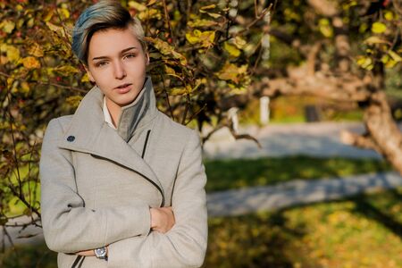 Modern girl with colored short hair in autumn