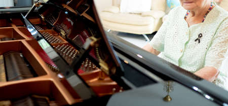 Senior Asian woman playing pianoの写真素材