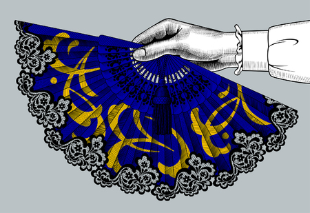 Female hand holding a blue open fan with yellow ornament. Vintage color engraving stylized drawing. Vector illustrationのイラスト素材