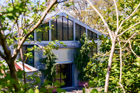 An interesting building made of corrugated tin and glass.の写真素材