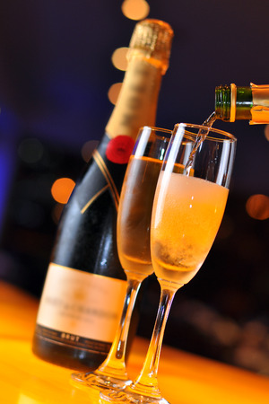 Pouring Champagne into tall glassの写真素材