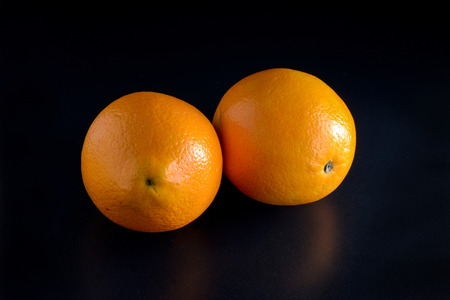Oranges on black backgroundの写真素材