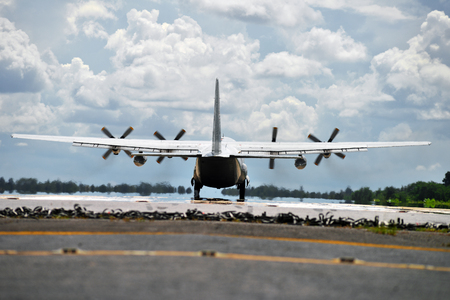Military transport aircraft landing on runwayの写真素材