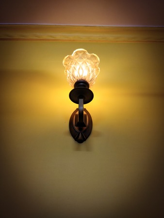 Vintage light bedroom lamp on a wallの写真素材