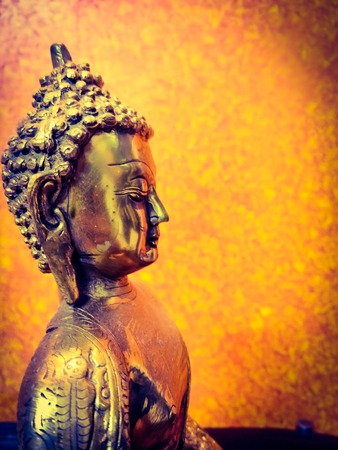 Golden close up shot of Lord Gautam Buddha statue or sculptureの写真素材