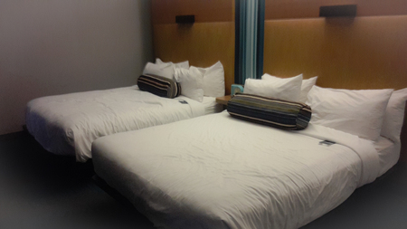king size beds in a hotel roomの写真素材