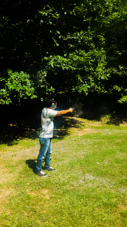 man practicing and aiming shot to targetの写真素材
