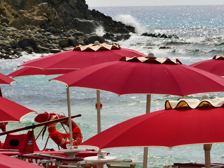 Red umbrealla and seaの写真素材