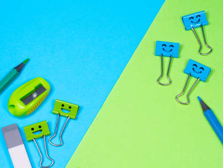 Smiles Binder Clips with Pencils and Pencil Sharpener. Office supplies on table. Education concept....