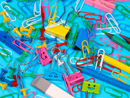 Paper clips on blue background. View from above with copy space School supplies on pink background....
