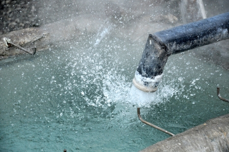 Hot water from geothermal spring to be transported by pipe  to fill the pool for mineral water.の写真素材