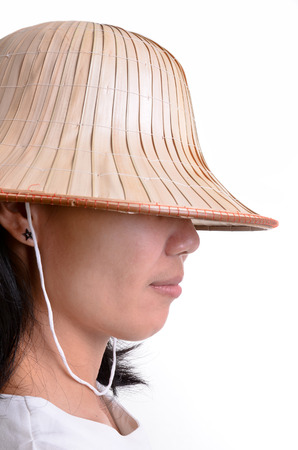 Girl with the conical Asian hat on white background の写真素材