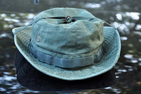 Green military boonie hat on black background.の写真素材