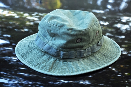 Green military boonie hat on black background.の写真素材