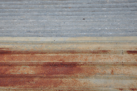 New and old corrugated zinc sheets are laid to overlap の写真素材