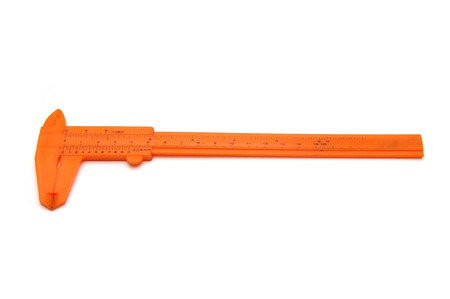 Orange vernier caliper isolated on white backgroundの写真素材