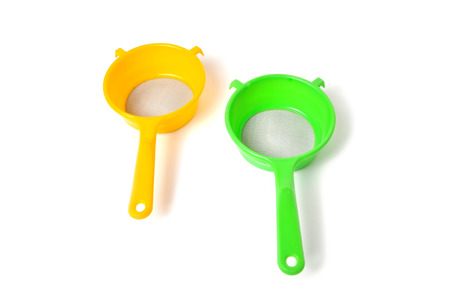 Yellow and Green handle colander isolated on white backgroundの写真素材